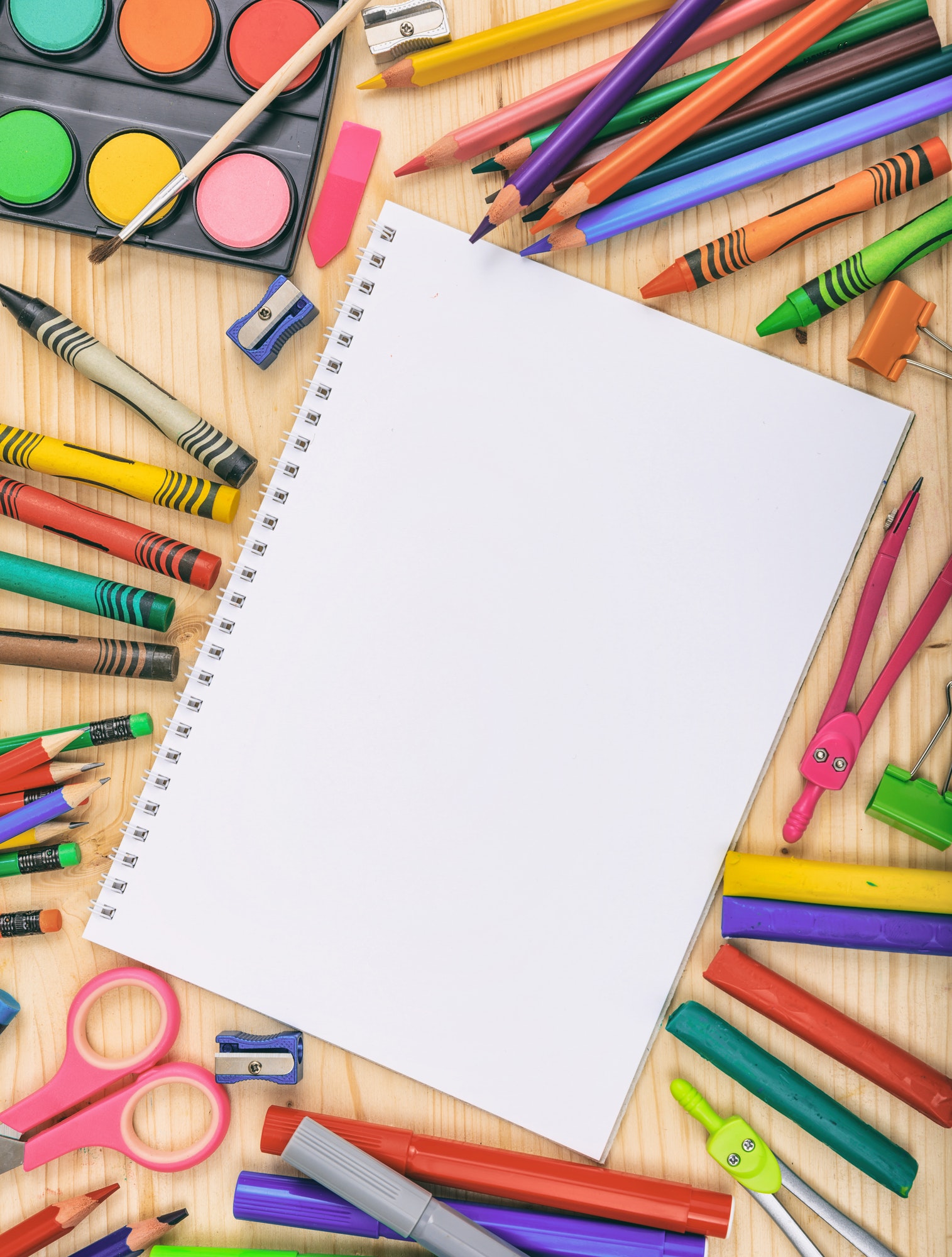 School supplies on wooden desk. Kid creativity flat lay